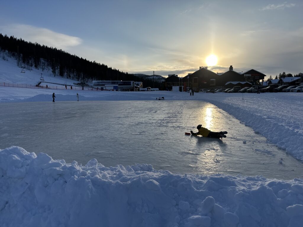 An outdoor ice rink in Levi in the low winter sun